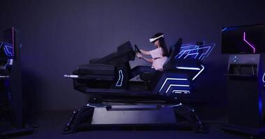 A woman is sitting in a chair with a headset on video
