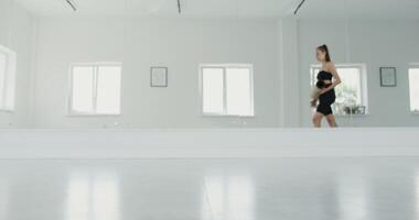 A woman is standing in front of a mirror video