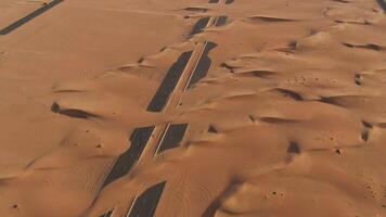 An aerial view of a desert with two tracks video