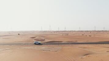 A car driving through the desert with power lines in the background video