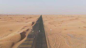 A long empty road in the desert with sand dunes video