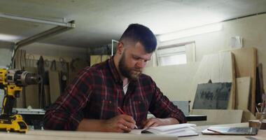 A man is working on a project in a woodworking shop video