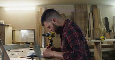 A man is working on a project in a woodworking shop video