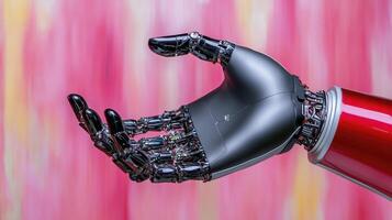 A robotic hand is holding a red object photo