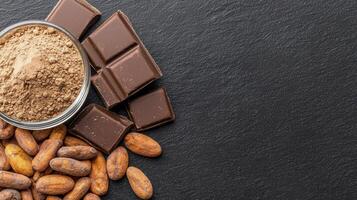 Chocolate powder, cocoa beans and nuts on a black background photo