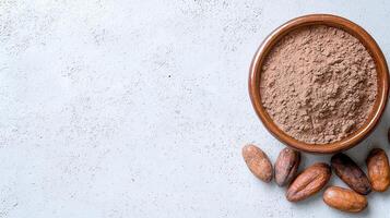 Cocoa powder in a bowl and cocoa beans on a white background photo