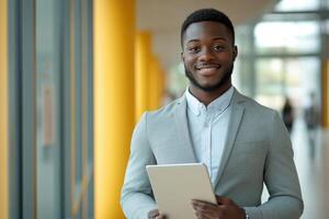 Smiling man in jacket holding a tablet. Business person with digital device. Happy person using technology. Professional with warm expression. photo