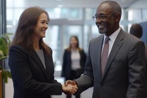 Business people shake hands. Meeting in office. Woman and man are smiling. Professional workers in suits. Deal success and collaboration. photo