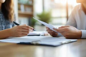 Office work. Paper review. Person holding document. Woman with pen. Sheet on desk. Business concept. Teamwork in progress. photo