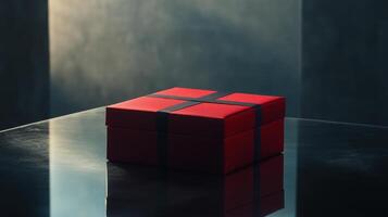 Red gift box. Dark background. Gift with ribbon. Square package. Surprise present. Simple gift. Black ribbon detail. Shiny reflection. photo