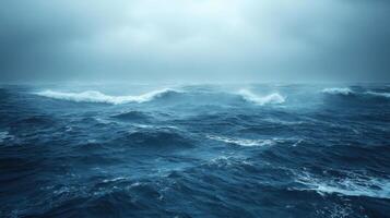 Ocean waves rolling. Dark sky above blue sea water. Stormy weather background. Wide view of seascape. Overcast day at the beach. photo