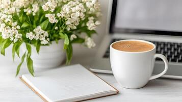 Minimalist setup featuring a blank calendar, coffee mug, and open notebook on a clean desk photo
