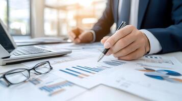 group of colleagues discussing data trends around a table filled with detailed financial reports and charts photo