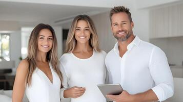 Professional real estate agent explaining property details to a young couple using a tablet in stylish living room photo
