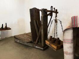 Vintage wooden weighing scale with metal weights in a rustic setting photo
