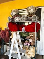 Plush toys on a shelf with decor in a bright colorful shop display photo