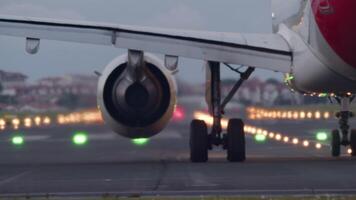 Passenger airplane accelerates down the runway, lifting off into the sky from an airport during twilight hours video