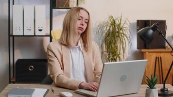 Businesswoman working on laptop meditating doing yoga breathing exercise in lotus position at office video