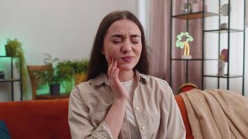 Dental problems, young woman touching cheek suffer from painful toothache, sensitive teeth, cavities video