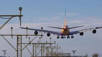 Massive passenger jet landing gracefully on airport runway, smoothly approaching localizer antenna array during precise instrument approach video