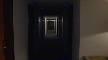 Large plush teddy bear wearing black boxer shorts resting motionless on hotel corridor carpet, creating surreal scene of playful loneliness during quiet evening video