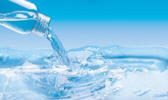 A large surface of water and a glass bottle pouring water with a spray effect. Blue color background with copy space photo