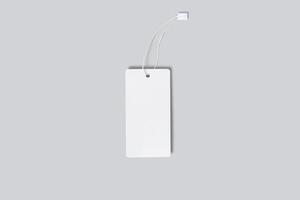 Mockup of a vertical empty white tag for clothes on a gray background. Template for your logo design photo