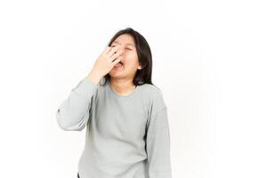 A woman is blowing her nose while standing photo