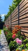 Beautiful Garden Fence with Flowers and Pebble Pathway photo