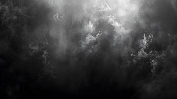 Monochrome photo of a cloudy sky with sun rays peeking through cumulus clouds