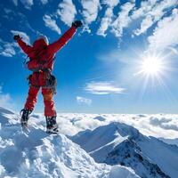Person on snowy mountain peak with arms raised in celebration photo