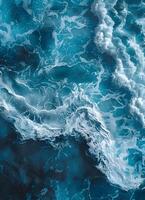 an aerial view of a large body of water with waves crashing on the shore photo