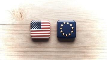 Two square tiles featuring the flags of the USA and Europe are placed side by side on a wooden surface, symbolizing transatlantic relations and unity. photo