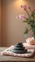 Spa stones and flowers on wooden table, closeup. Zen concept with copy space for text photo
