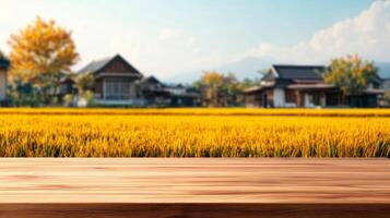 Wooden empty table top on blurred rice field background for display or montage your products photo