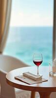 Wine glass and napkin on table with sea view background on rest or holiday photo