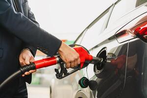 Close-up of man's hand filling up car at gas station with equipment ZVA photo