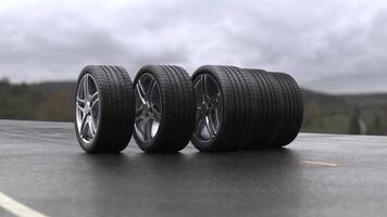 Loop four car wheels rolling on wet asphalt against the background of mountains video