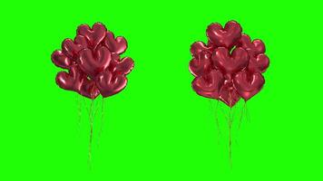 Loop Bundle of red heart-shaped balloons on a green background video