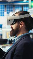 Vertical Photovoltaics factory expert using VR tech to build models of renewable energy generators. Solar panels plant technician building environmentally safe solar cells using virtual reality gear, camera A video