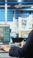 Vertical Photovoltaics factory engineer adjusting system parameters on PC to maximize solar cells power generation. Technician optimizing energy supply in solar panel manufacturing plant, camera A video