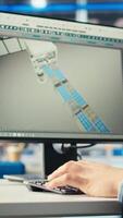 Vertical Photovoltaics factory engineer using program on PC to improve solar panels efficiency. Solar panels manufacturing plant worker researching cheaper solar solutions using computer, camera A close up video