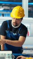 Vertical Photovoltaics factory manager delegating tasks to employee, improving solar panels efficiency. Team leader sends worker to make adjustments after researching more sustainable solar solutions, camera B video