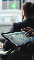 Vertical Photovoltaics factory specialist designs production lines in CAD app using tablet. Solar panels plant technician uses simulation software on device to optimize production layouts, camera A closeup video