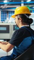 Vertical Solar panels manufacturing plant technician uses CAD program to optimize layouts. Photovoltaics factory staff member doing arrangements for maximum renewable energy output, camera A video