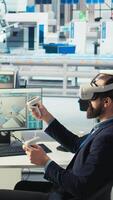 Vertical Engineer in photovoltaics factory using virtual reality technology to diagnose malfunctioning systems. Solar panels manufacturing plant worker using VR headset to reduce downtime, camera A video