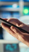 Vertical Engineer in photovoltaics factory using tracking software on tablet to diagnose malfunctioning systems. Solar panels manufacturing plant worker uses device to reduce downtime, camera B closeup video