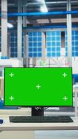 Vertical Chroma key mockup computer in empty photovoltaics factory used to diagnose malfunctioning systems. Isolated screen PC in solar panels manufacturing plant used for reducing downtime video