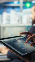 Vertical Solar panels plant employee uses CAD software on tablet to optimize layouts. Photovoltaics factory worker doing arrangements for maximum energy output using device, camera A close up video