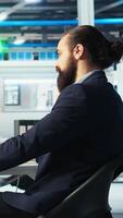 Vertical Photovoltaics factory manager brainstorms with colleague, analyzing data, reviewing metrics. Solar panels plant coworkers collaborates to troubleshoot technical issues, diagnosing faults, camera A video